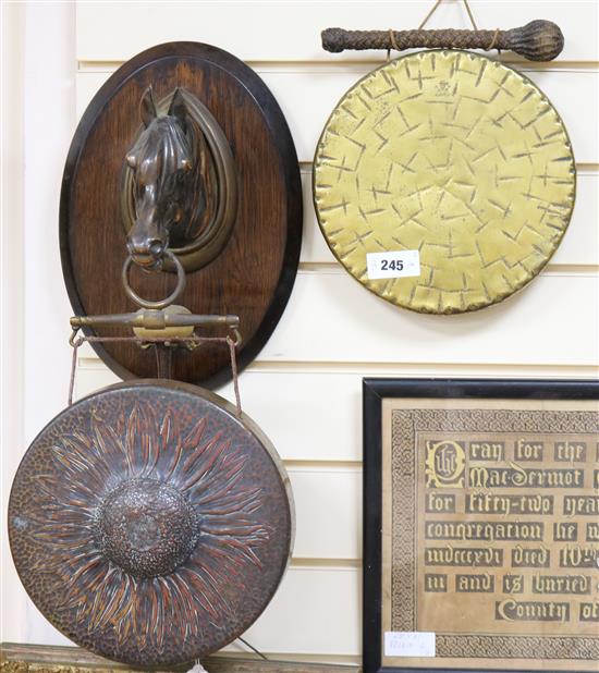 A brass horse head wall gong and another gong